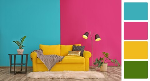 Stylish living room with comfortable sofa near colorful wall. Interior design and matching color palette